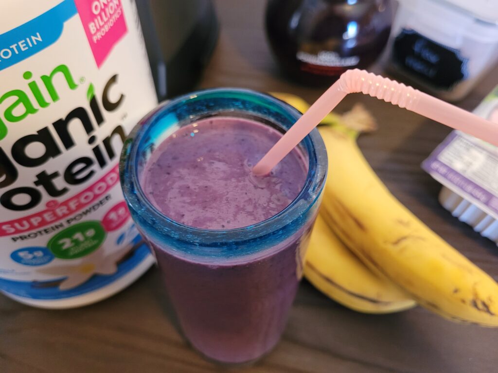 Complete Hunger-Curbing Antioxidant Meal Smoothie in a glass with a straw.